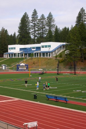 Students practicing their sports on a grass field